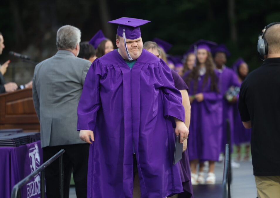 A graduate walks back to his seat after receiving his diploma at the 2024 graduation ceremony.