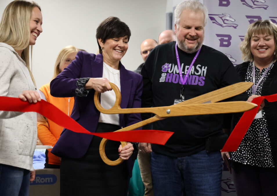 Burlington School Board members Christi Burghoffer, Darven Kendell and Anika McVay hold a ribbon being cut by Burlington High School Principal Monica Myers Monday, Feb. 19, in the health occupations lab at BHS.